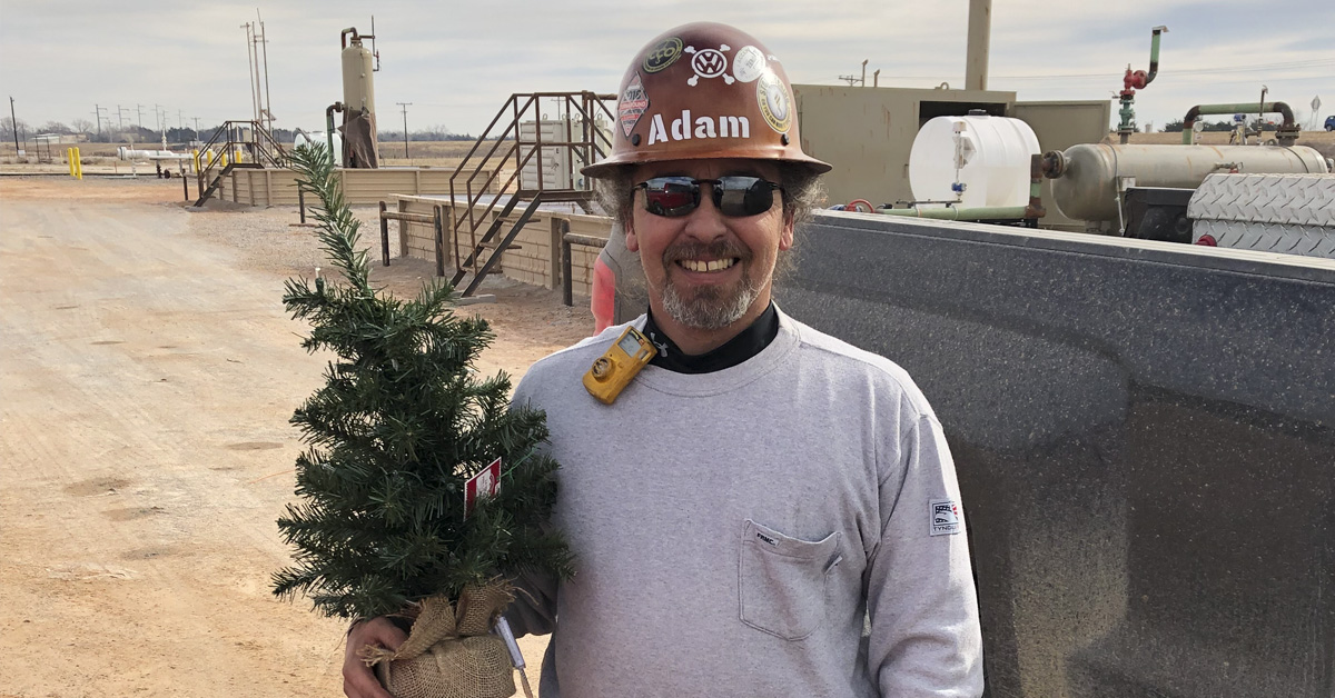 Adam with a Christmas Tree donated by a reader