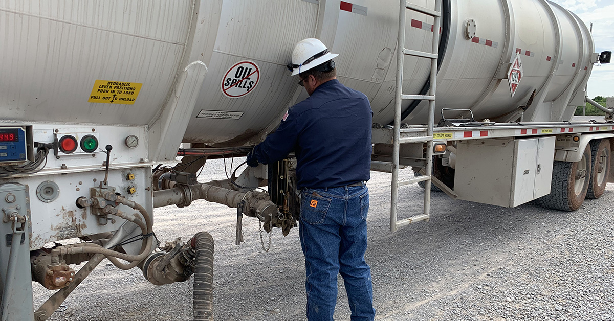 Trucker visiting a well site to pick up oil