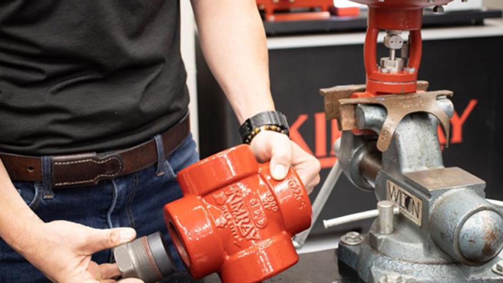Kimray Team Member Showing T-Body Wear Plug