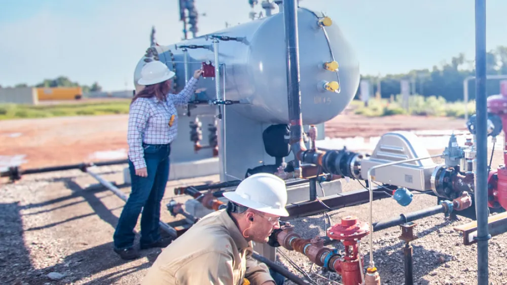 Kimray Team Members Inspecting Products at a Well Site
