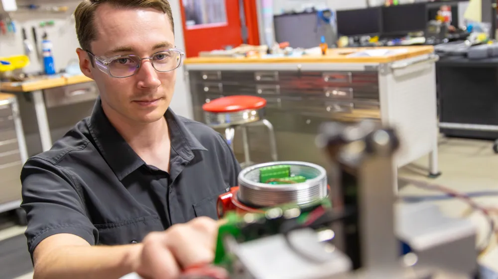 Kimray Engineer Making Adjustments to Testing Equipment