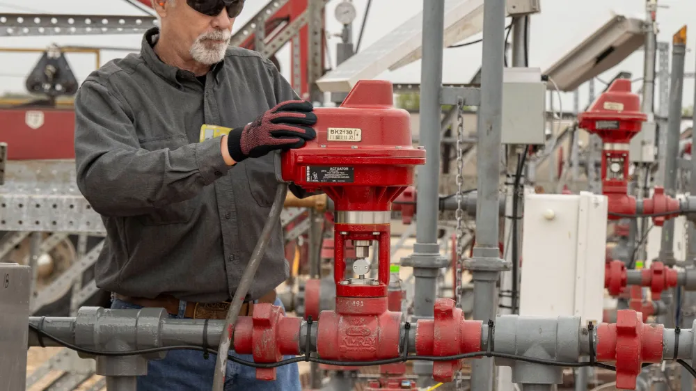 Kimray Team Member Installing an Electric Actuator in the Field