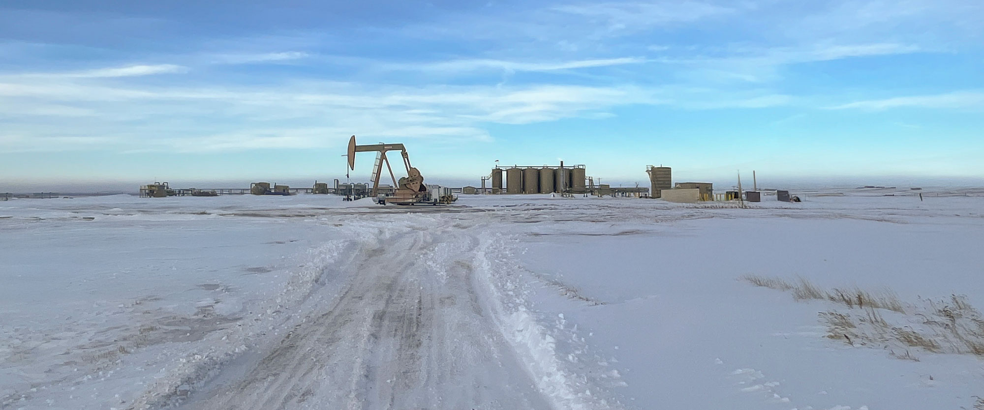 oil and gas well site in cold weather conditions with snow
